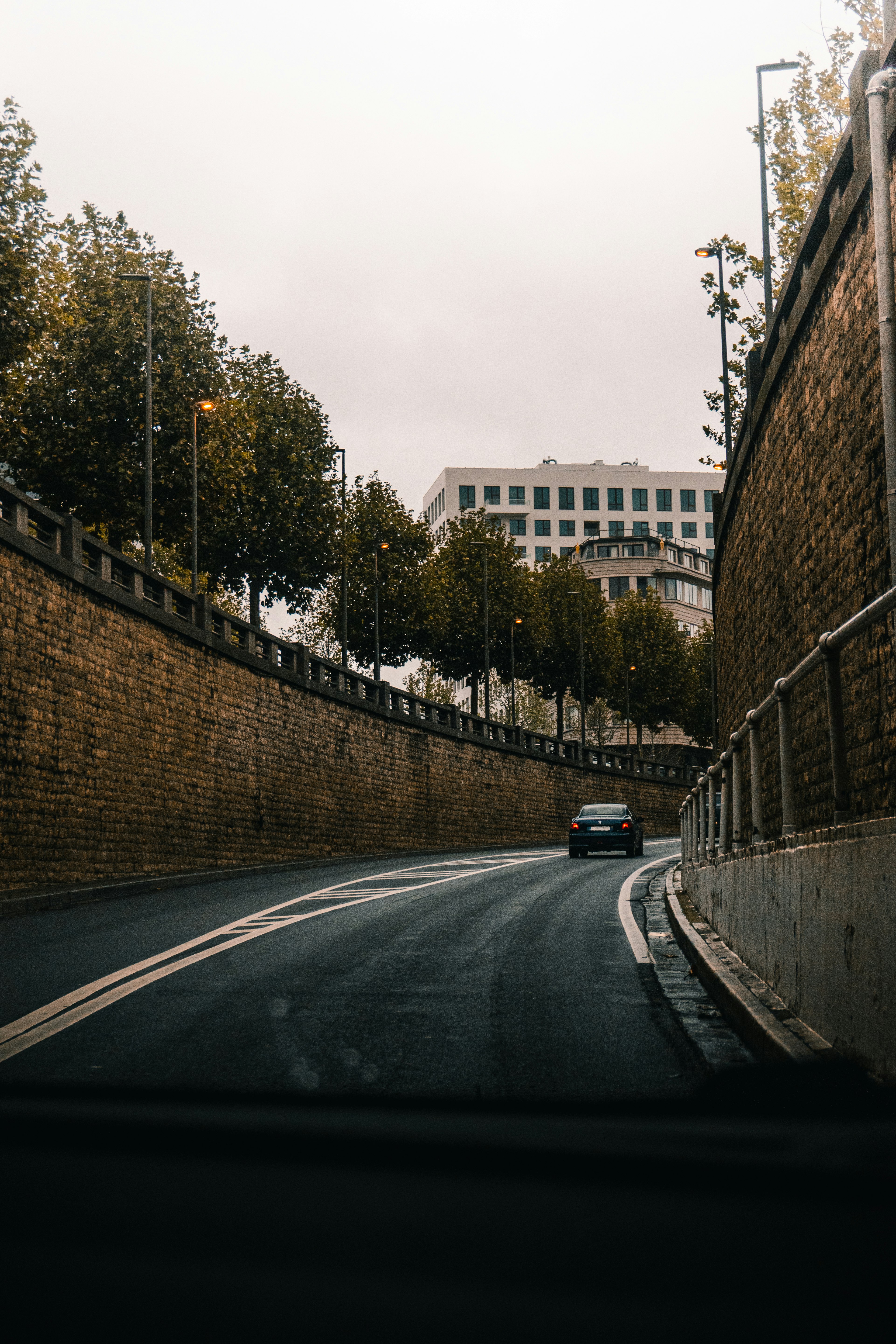 cars on road near brown concrete building during daytime